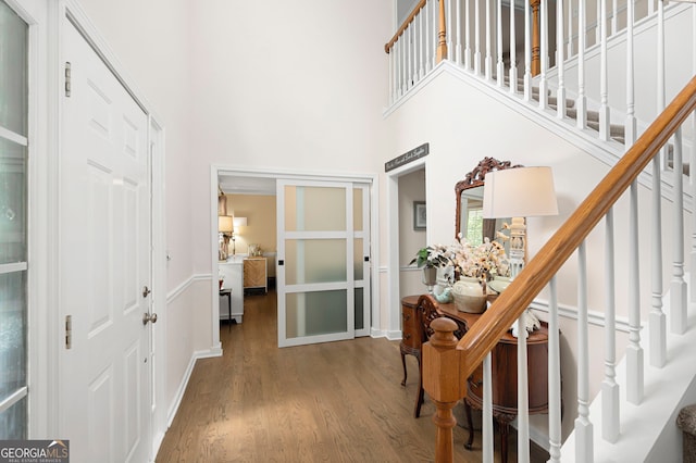57 Glenn Eagles Way, Hiram, GA 30141 - entrance foyer featuring wood finished floors, a towering ceiling, stairway, and baseboards