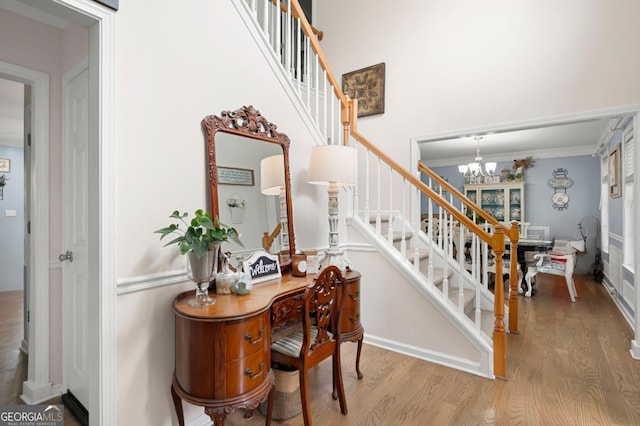 57 Glenn Eagles Way, Hiram, GA 30141 - staircase featuring wood finished floors, a chandelier, baseboards, and a towering ceiling