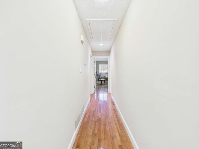 1961 Mars Hill Rd, Watkinsville, GA 30677 - hall featuring light wood finished floors, attic access, baseboards, and visible vents
