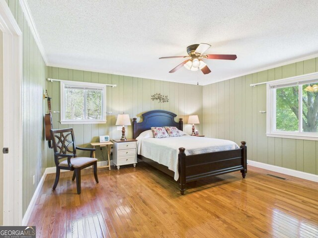 1961 Mars Hill Rd, Watkinsville, GA 30677 - bedroom featuring hardwood / wood-style flooring, baseboards, crown molding, and a textured ceiling