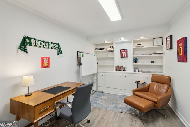 office space featuring light wood-style floors and crown molding