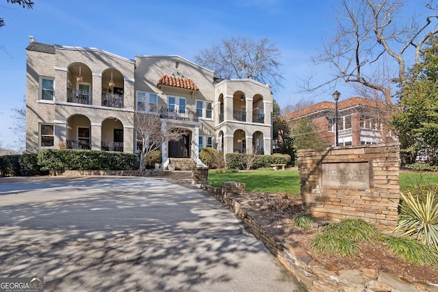 view of front of house with a balcony and stucco siding