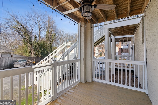 deck featuring stairway, fence, and a ceiling fan