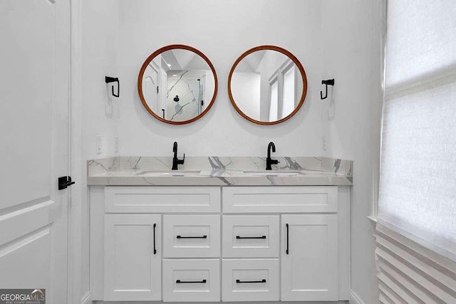 bathroom with double vanity and a sink