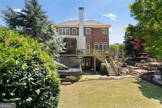 4675 Lakeway Pl, Alpharetta, GA 30005 - back of house featuring stairway, a trampoline, a deck, a yard, and brick siding