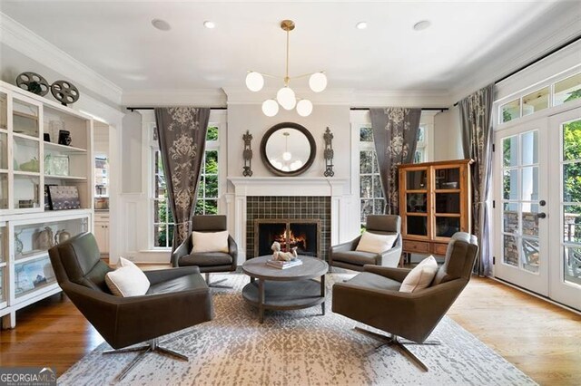 4675 Lakeway Pl, Alpharetta, GA 30005 - sitting room with a tile fireplace, wood finished floors, and ornamental molding