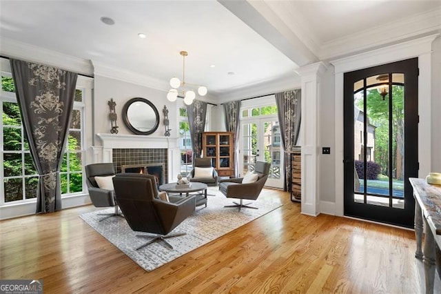 4675 Lakeway Pl, Alpharetta, GA 30005 - living area with a tile fireplace, crown molding, and light wood-style flooring