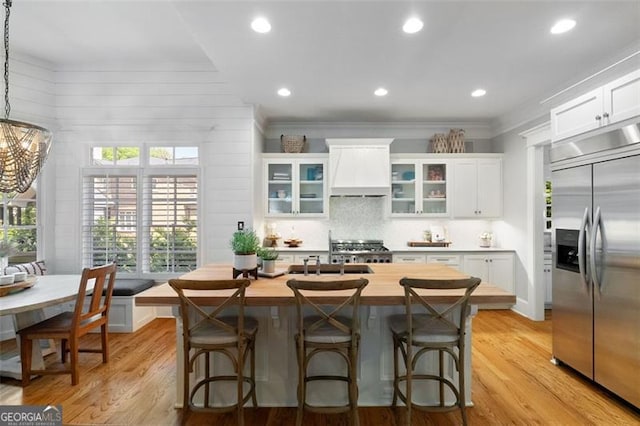 4675 Lakeway Pl, Alpharetta, GA 30005 - kitchen featuring white cabinets, breakfast area, built in fridge, butcher block countertops, and custom exhaust hood
