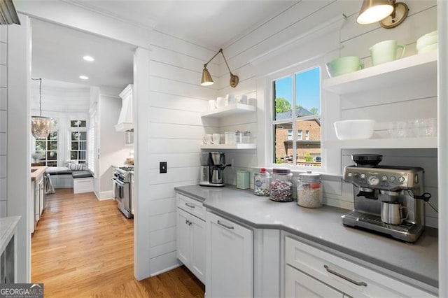 4675 Lakeway Pl, Alpharetta, GA 30005 - kitchen with light wood-type flooring, white cabinetry, open shelves, light countertops, and stainless steel range