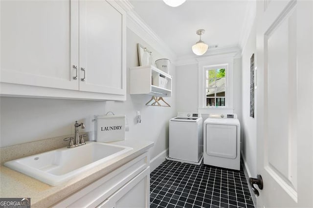 4675 Lakeway Pl, Alpharetta, GA 30005 - washroom with ornamental molding, a sink, washing machine and dryer, baseboards, and dark tile patterned flooring