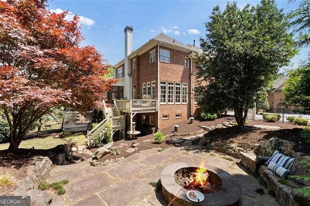 4675 Lakeway Pl, Alpharetta, GA 30005 - rear view of property with stairway, a chimney, fence, a wooden deck, and a fire pit