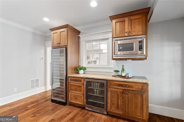 4675 Lakeway Pl, Alpharetta, GA 30005 - bar featuring stainless steel microwave, beverage cooler, visible vents, and baseboards