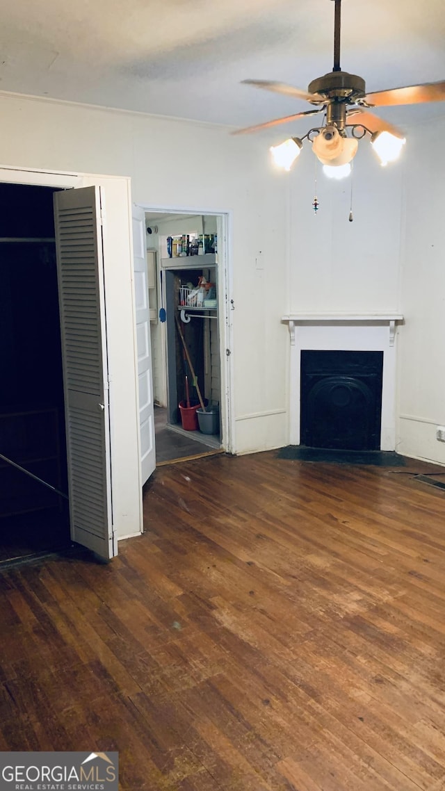 unfurnished living room with a fireplace with flush hearth, ceiling fan, and hardwood / wood-style floors