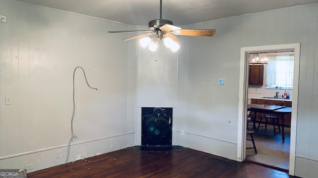 interior space with ornamental molding, wood finished floors, a sink, and ceiling fan