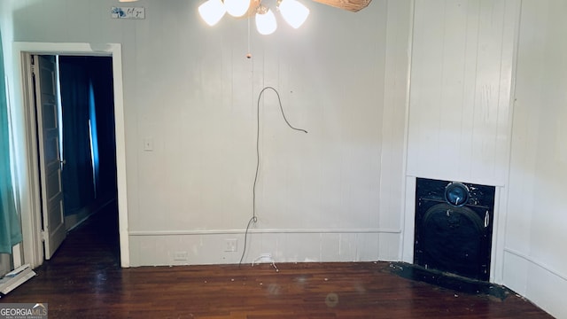 unfurnished living room with a ceiling fan and wood finished floors