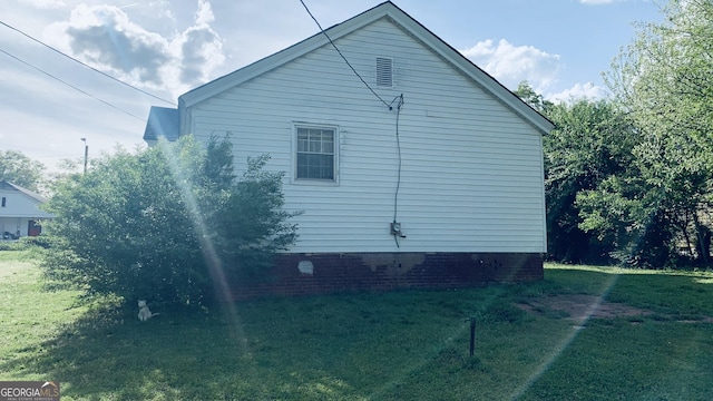 view of side of home featuring a yard