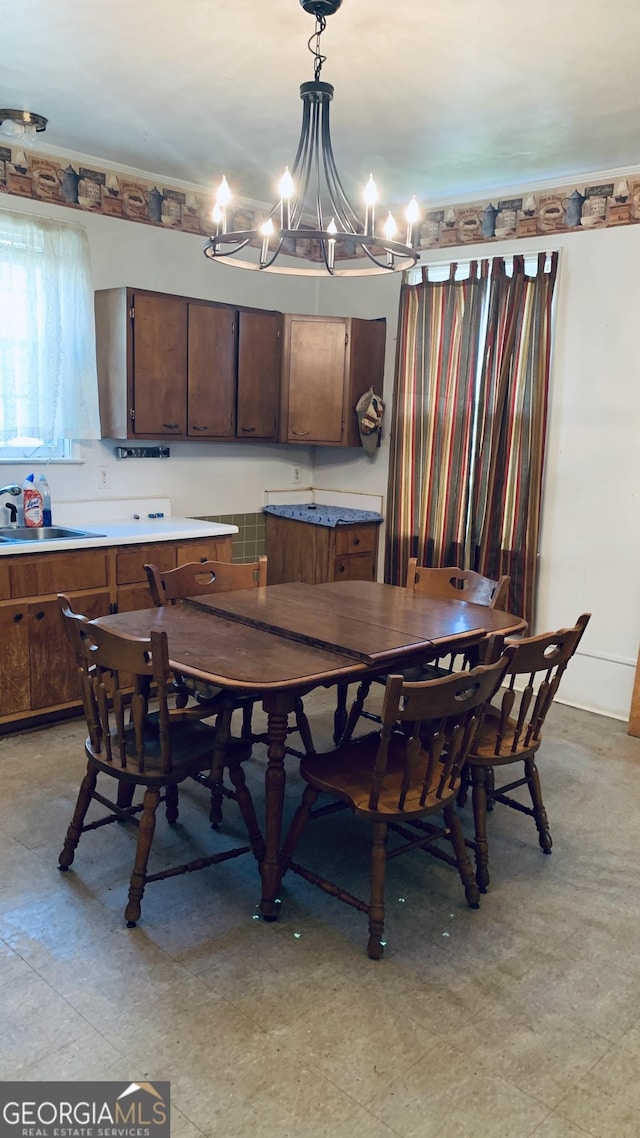 dining room featuring a notable chandelier and light floors