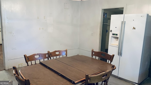 dining space featuring concrete flooring