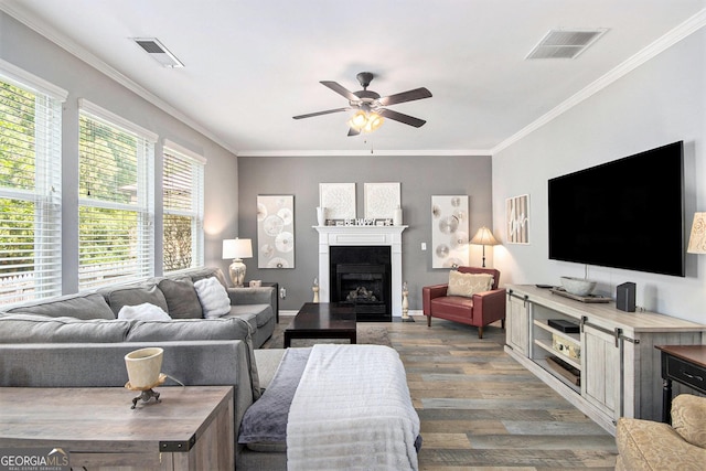 4440 Spring Mtn Ln, Powder Springs, GA 30127 - living room with ceiling fan, wood finished floors, ornamental molding, and a fireplace