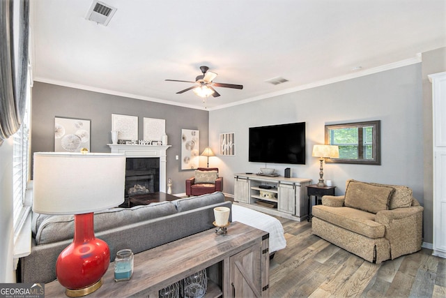4440 Spring Mtn Ln, Powder Springs, GA 30127 - living room featuring a fireplace, wood finished floors, visible vents, and a ceiling fan