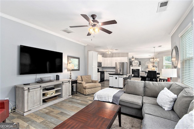 4440 Spring Mtn Ln, Powder Springs, GA 30127 - living room with ceiling fan, light wood finished floors, and crown molding