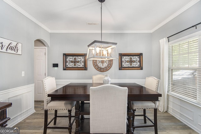 4440 Spring Mtn Ln, Powder Springs, GA 30127 - dining space with wood finished floors, arched walkways, a decorative wall, visible vents, and crown molding