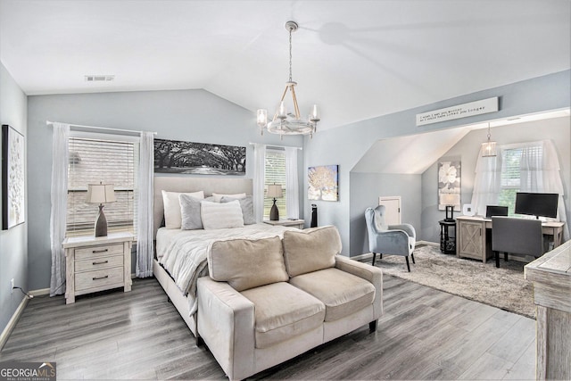 4440 Spring Mtn Ln, Powder Springs, GA 30127 - bedroom with vaulted ceiling, a chandelier, and wood finished floors