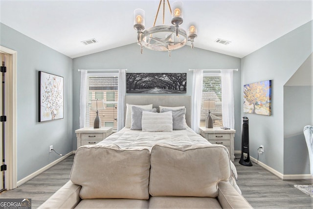 4440 Spring Mtn Ln, Powder Springs, GA 30127 - bedroom with light wood finished floors, lofted ceiling, and a chandelier