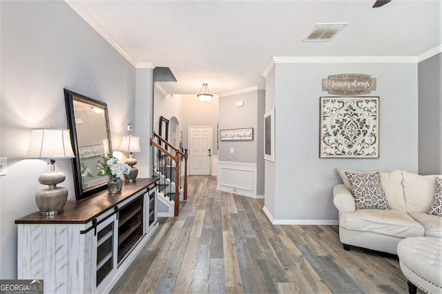 4440 Spring Mtn Ln, Powder Springs, GA 30127 - living area featuring ornamental molding, wood finished floors, stairway, and a wainscoted wall