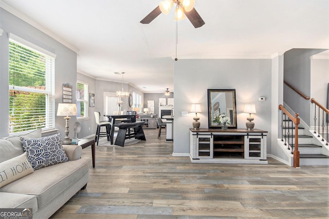 4440 Spring Mtn Ln, Powder Springs, GA 30127 - living room featuring ceiling fan, wood finished floors, crown molding, stairs, and a chandelier