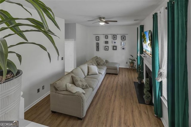 831 Kendall Park Dr, Winder, GA 30680 - living area with ceiling fan, wood finished floors, and baseboards