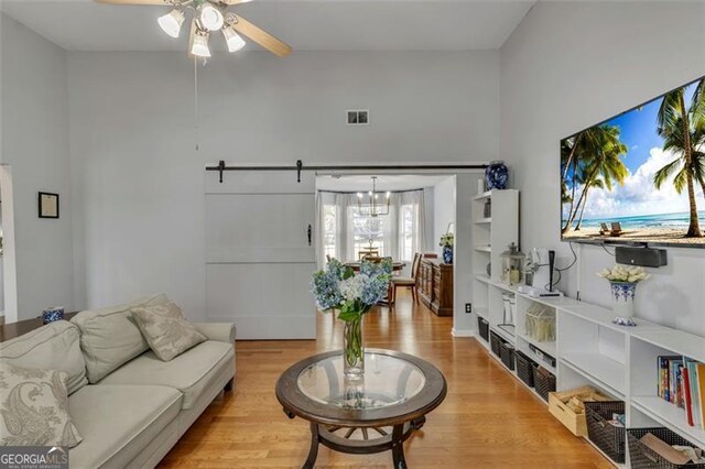 831 Kendall Park Dr, Winder, GA 30680 - living room with a ceiling fan, wood finished floors, and a barn door