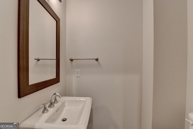 half bath with a sink and toilet