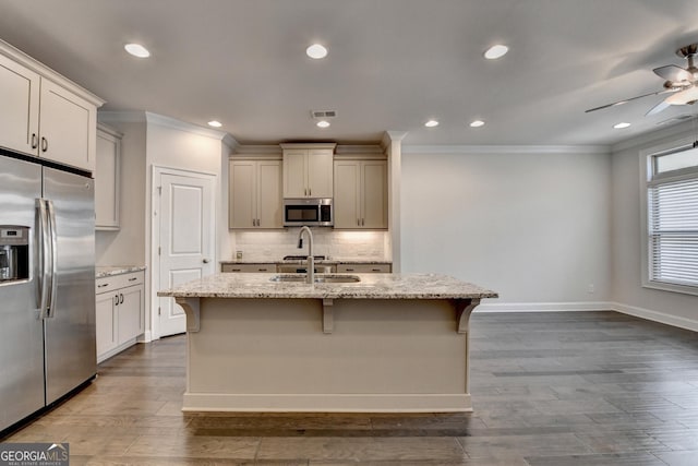 kitchen featuring crown molding, a ceiling fan, stainless steel appliances, and a sink
