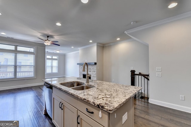 kitchen featuring dishwasher, a ceiling fan, baseboards, and a sink