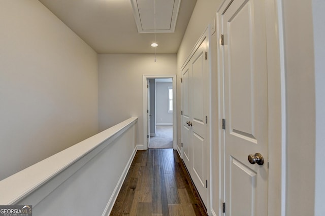 hall featuring attic access, dark wood finished floors, baseboards, and recessed lighting