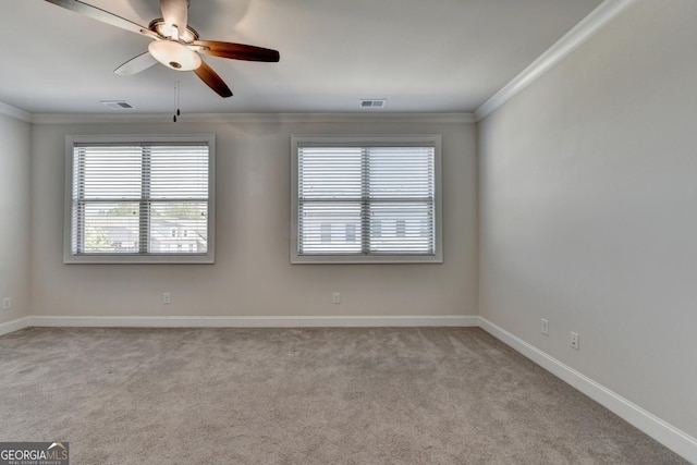 empty room featuring light carpet, ornamental molding, and visible vents