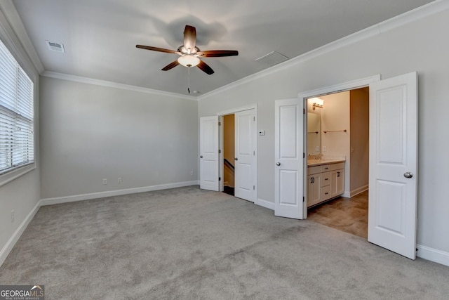 unfurnished bedroom with baseboards, visible vents, light colored carpet, ceiling fan, and crown molding