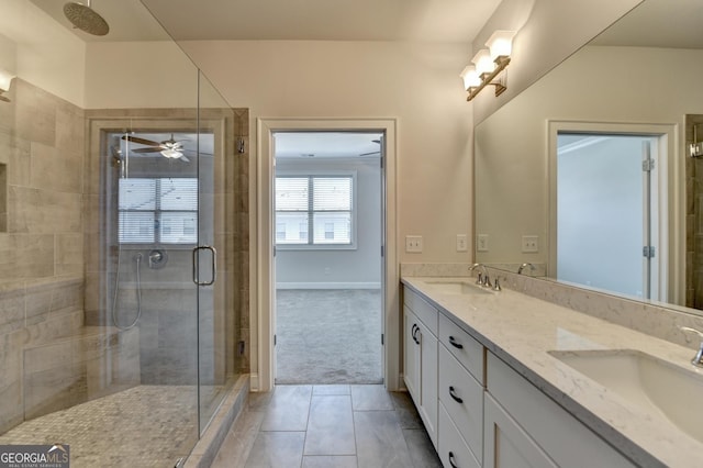 bathroom featuring double vanity, tile patterned flooring, a stall shower, and a sink