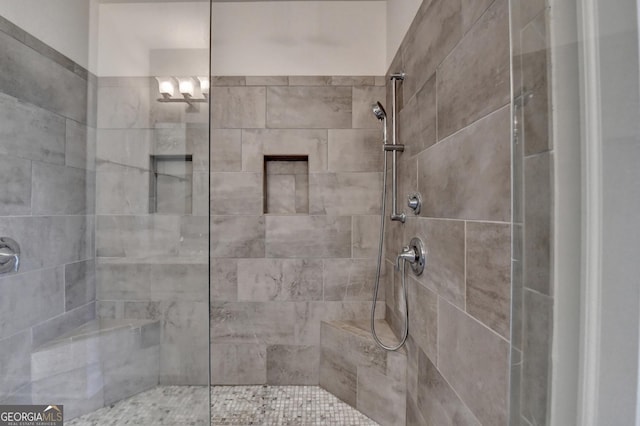 full bath featuring tiled shower