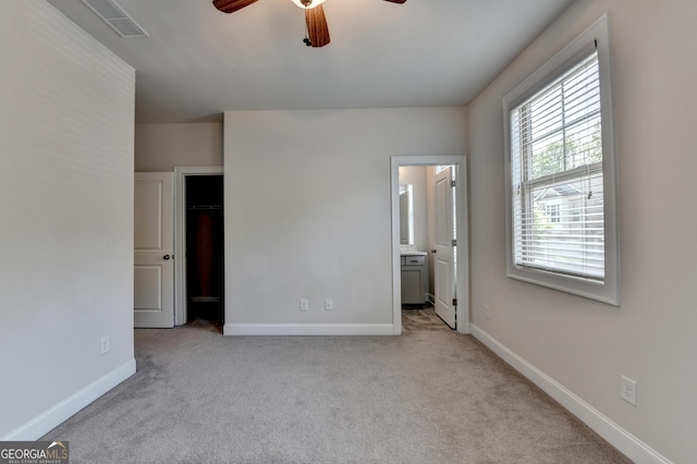 unfurnished bedroom featuring baseboards, carpet flooring, and visible vents