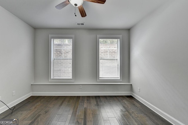 unfurnished room featuring baseboards, visible vents, a wealth of natural light, and ceiling fan