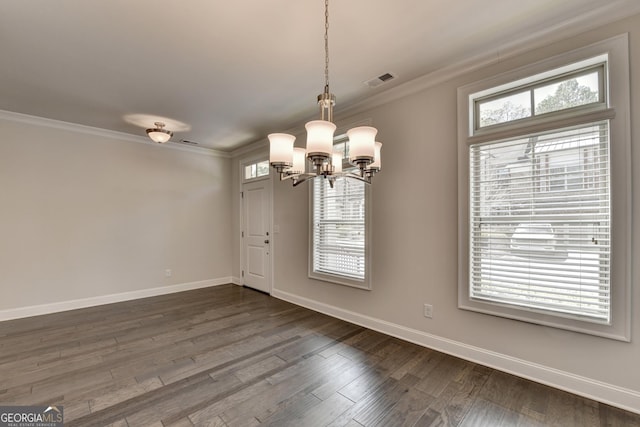 unfurnished dining area with baseboards, crown molding, a chandelier, and visible vents