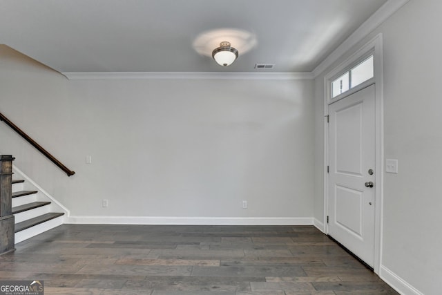 entryway with wood finished floors, visible vents, stairs, and ornamental molding