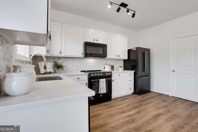 3552 Clear Creek Xing NW, Kennesaw, GA 30144 - kitchen with black appliances, white cabinetry, light stone countertops, and a sink