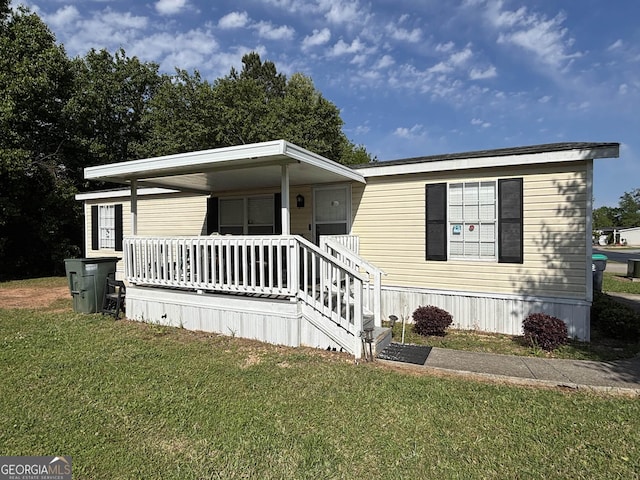 63 Breezewood Dr, Hampton, GA 30228 - manufactured / mobile home with a front lawn and covered porch