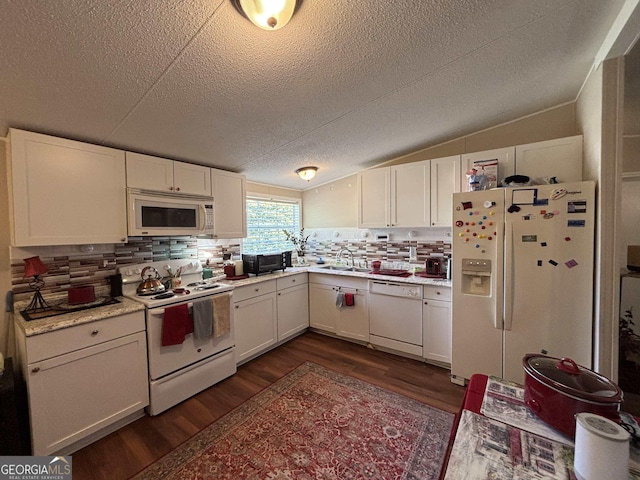 63 Breezewood Dr, Hampton, GA 30228 - kitchen with white appliances, dark wood-style floors, a textured ceiling, light countertops, and backsplash