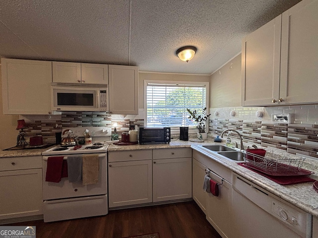 63 Breezewood Dr, Hampton, GA 30228 - kitchen featuring white appliances, dark wood-style floors, decorative backsplash, light countertops, and a textured ceiling