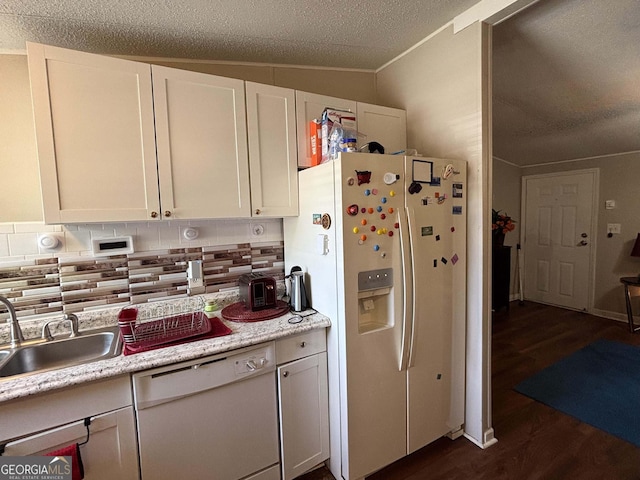 63 Breezewood Dr, Hampton, GA 30228 - kitchen featuring white appliances, lofted ceiling, dark wood-style floors, backsplash, and light countertops