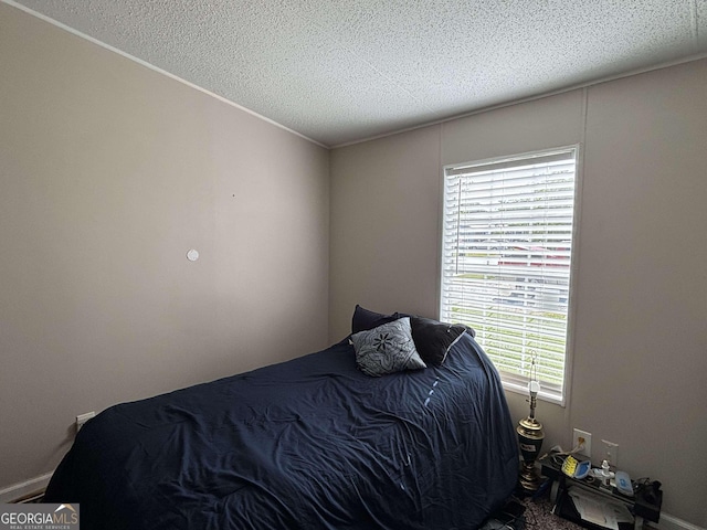 63 Breezewood Dr, Hampton, GA 30228 - bedroom featuring a textured ceiling and ornamental molding